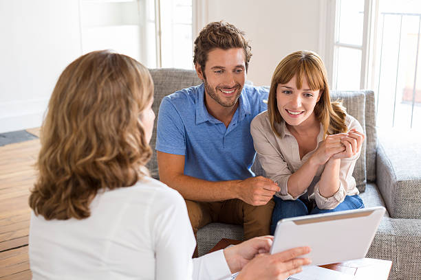 istock Architect presenting a new project on tablet to a couple 493687482