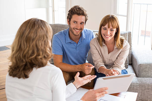 Real Estate Agent agent presenting a new project property on tablet pc