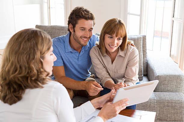 istock Real-estate agent presenting a new project property on digital t 493687582