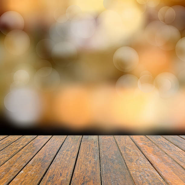istock Old wooden deck table with a sparkling bokeh 493687618