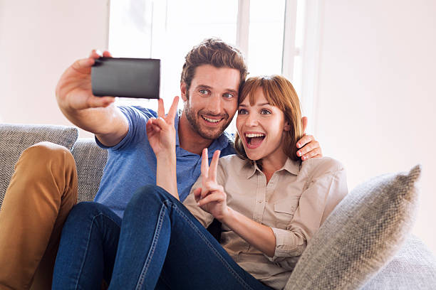 istock Happy couple taking a selfportrait with a cell phone 493688418