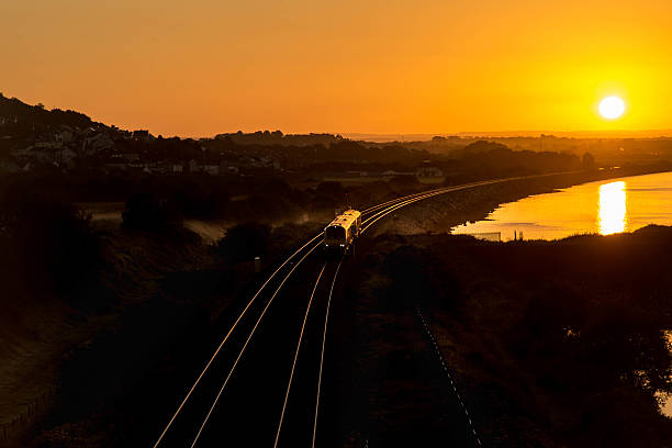 istock Train on coastal track at sunrise 493690286