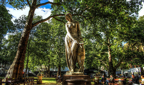 Statue in Berkeley Square London, United Kingdom - September 17, 2012: HDR image of Nymph statue by Alexander Munro, Berkeley Square (1858) with people sitting on benches during their lunch break.  2015 stock pictures, royalty-free photos & images