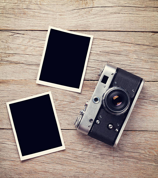 istock Vintage film camera and two blank photo frames 493690868