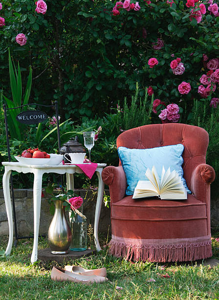 istock Relaxing in roses garden with a book 493690984