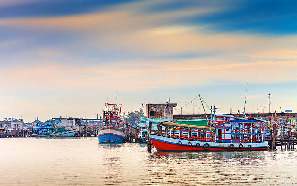 istock fisherman boat docking at pier in the sunset 493692150