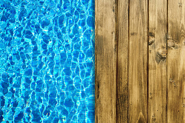 istock Swimming pool and wooden deck for backgrounds 493693870
