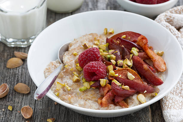 istock oatmeal with baked fruit and pistachios for breakfast, closeup 493695074