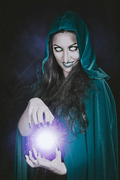 istock Halloween witch with fireball in her hands 493695828