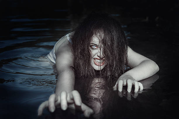 Young beautiful drowned ghost woman in the water stock photo