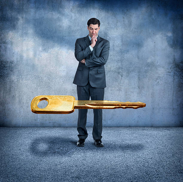 istock Businessman Looking At Key Floating In The Air 493696250