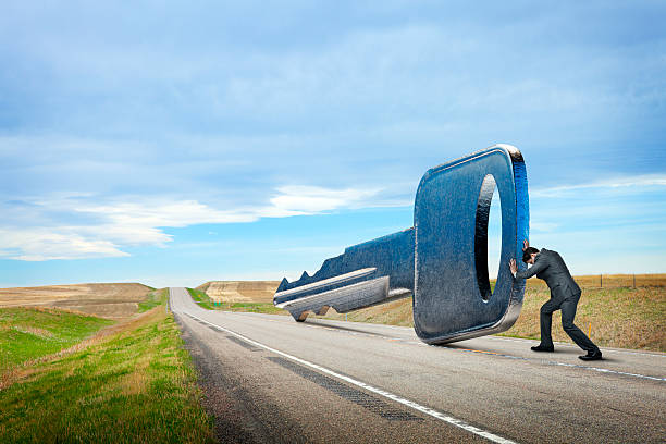 istock Businessman Is Pushing Key Down A Rural Road 493697142