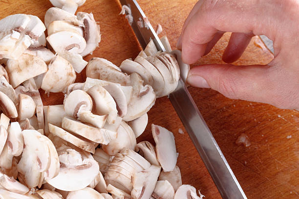 istock Champignon mushrooms sliced on wooden board 493697738