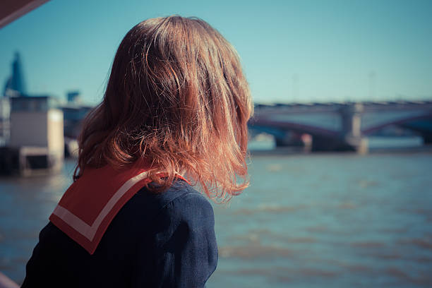 istock Woman relaxing on boat on the Thames 493704915