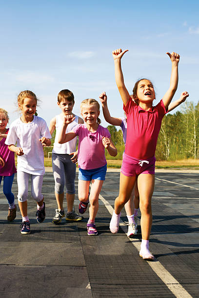group of children running on the treadmill at the stadium