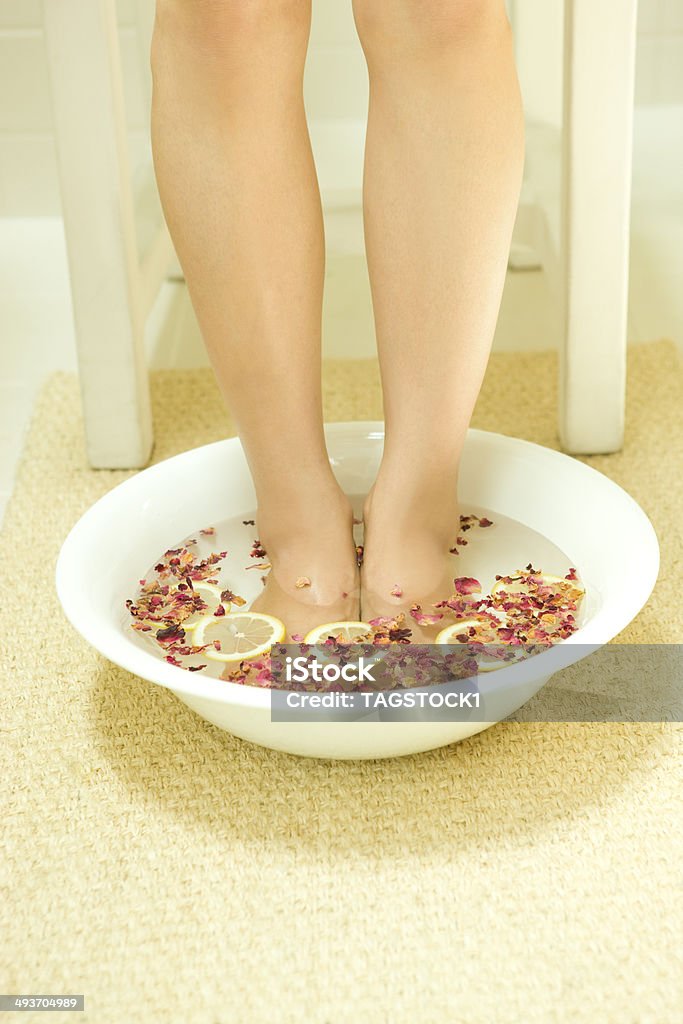 Woman in footbath of Rose Red and lemon Foot Bath Stock Photo