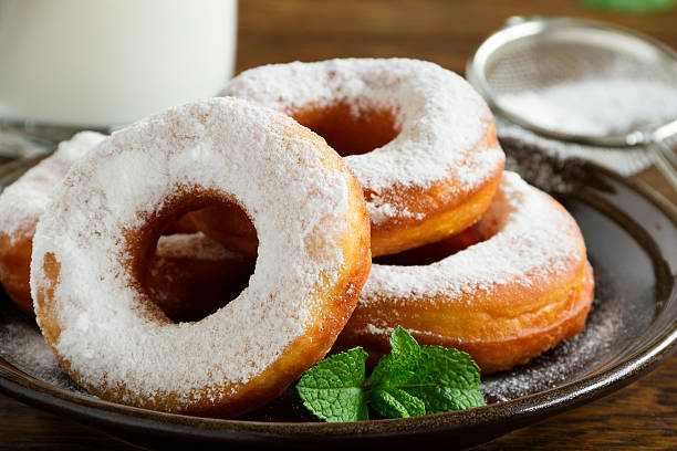 istock With vanilla cream donuts in powdered sugar. 493707067