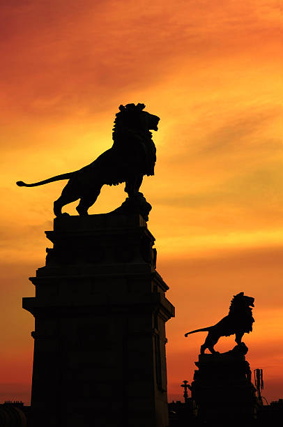 Vienna's Nussdorf weir and lock with its lion statues on the Schemerl bridge silhouetted against sunset. The Nussdorfer weir is a well known landmark in Vienna built by Otto Wagner, the lions are the work of Rudolf Weyr and were the model for the Austrian automobile manufacturer Graef & Stift.