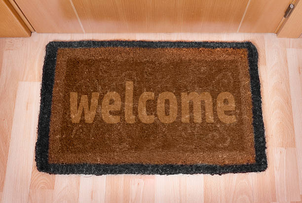 istock Welcome home doormat with closed door 493710045