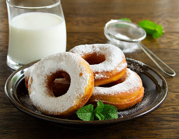 istock With vanilla cream donuts in powdered sugar. 493711403