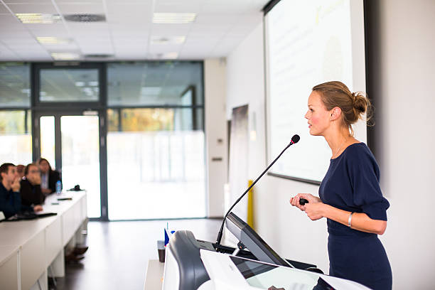istock Pretty, young business woman giving a presentation 493711405