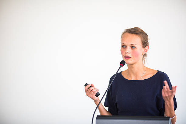 istock Pretty, young business woman giving a presentation 493711409