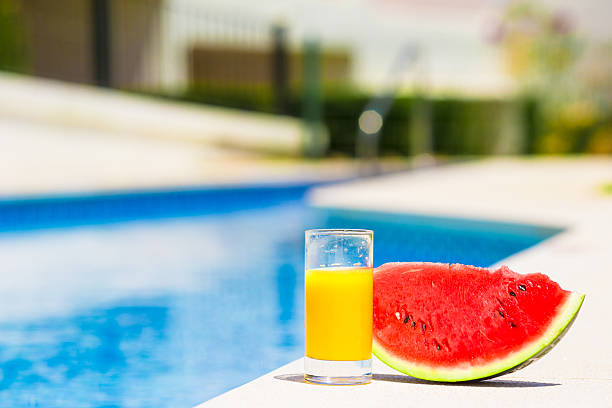 Summer theme: watermelon and orange juice on green grass