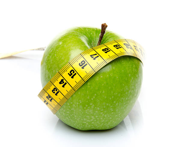 istock Measuring tape around a green apple 493711793