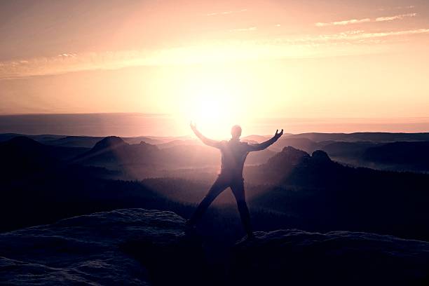 istock Jumping hiker in black celebrate triumph between two rocky peaks 493713468