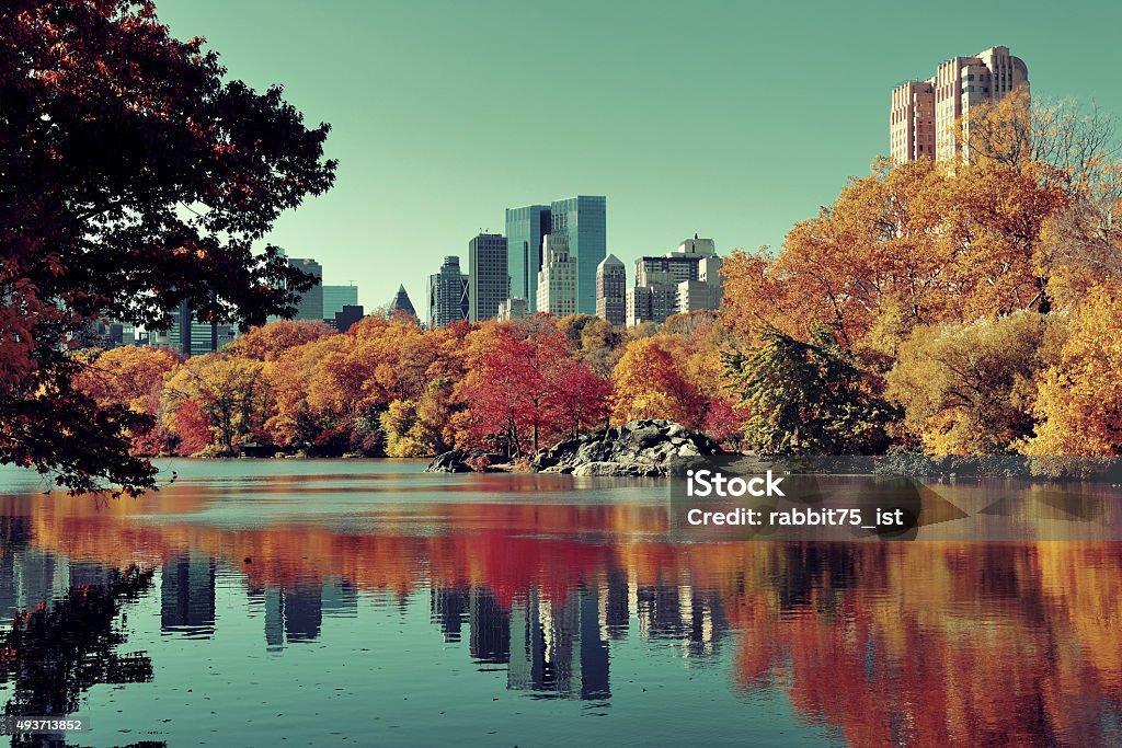 Central Park Autumn Central Park Autumn and buildings reflection in midtown Manhattan New York City 2015 Stock Photo
