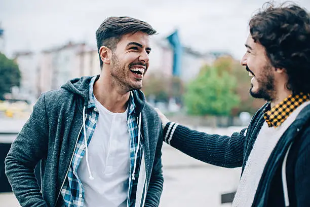 Smiling young men at urban scene