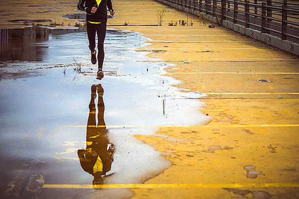 Young person running over the yellow parking lot stock photo