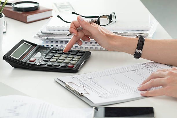 Close up of female accountant or banker making calculations Close up of female accountant or banker making calculations. Savings, finances and economy concept Bureaucracy stock pictures, royalty-free photos & images