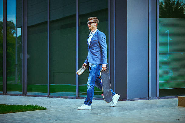 istock Young entrepreneur carrying skateboard on the way to work 493715224