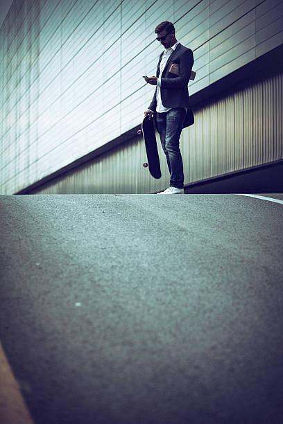 istock Young casual businessman using smartphone in the urban environment 493715336
