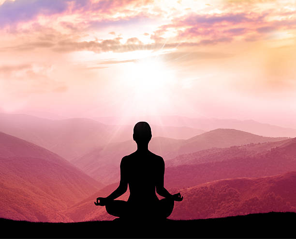 istock Meditation. Silhouette of man in the mountain 493716340