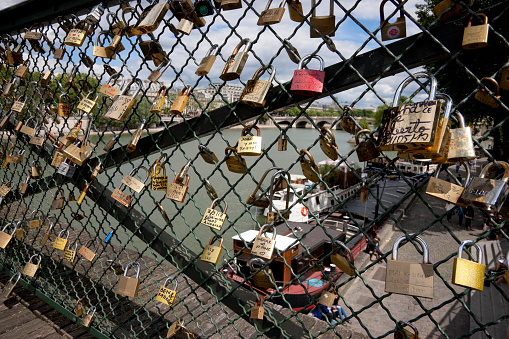 Paris, France -- June 9, 2012: Love and Friendship Locks on the Pont des Arts Bridge over Seine