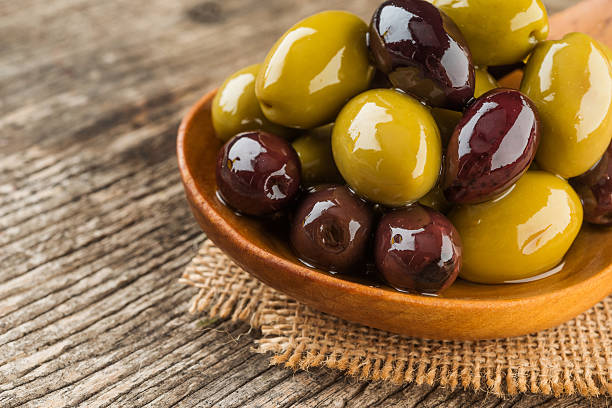 istock Mixed olives in wooden spoon 493718100