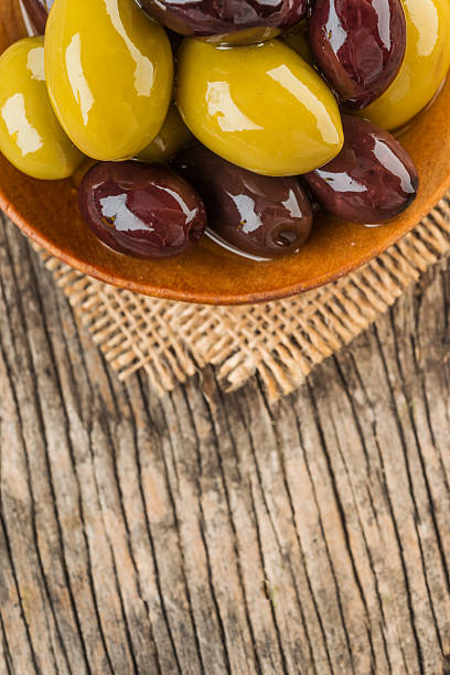 istock Mixed olives in wooden spoon 493718264