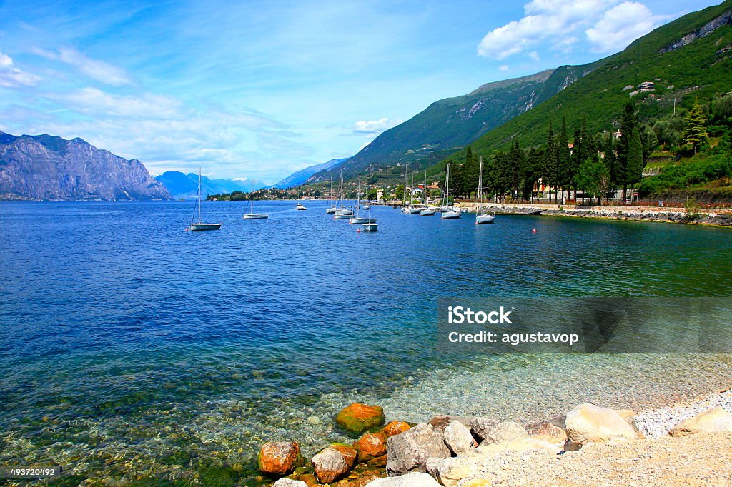 Yacht ship and Italian turquoise translucent Lake Garda paradise, Malcesine Verona - Italy Stock Photo