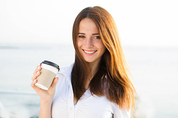 jeune femme buvant un café - beach on child the photos et images de collection