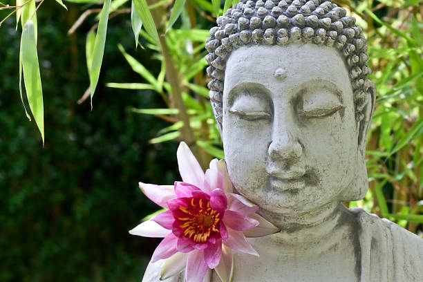 istock Buddha with lotus and bamboo leaves 493722580
