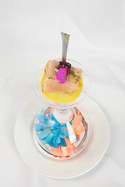 Amuse Bouche In House cured and smoked Pork prosciutto on Up side down wine glass presentation with array of flowers amuse stock pictures, royalty-free photos & images