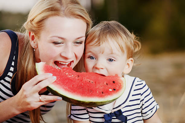 istock Kid at countryside eating watermelon. 493725816