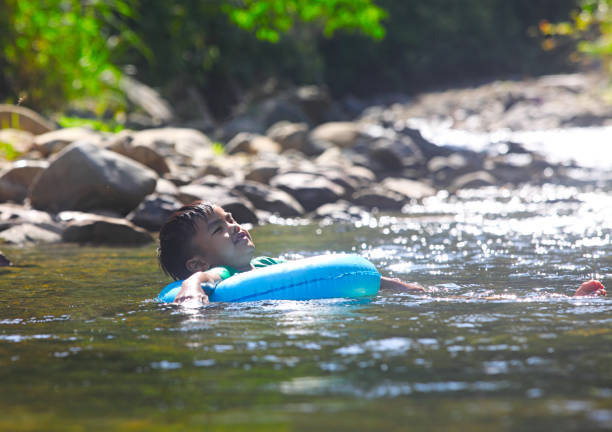 istock Children playing in the stream 493735814