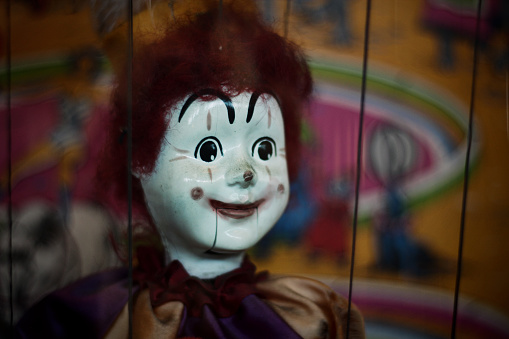 Detail photo of an antique and slightly creepy clown marionette puppet.