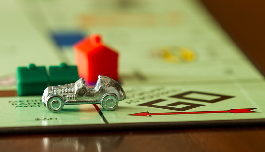 Boise, USA - November 18, 2012: BOISE, IDAHO - NOVEMBER 18, 2012: Car from the game Monopoly speeding past. Game was made by Parker Brothers now owned by Hasbro