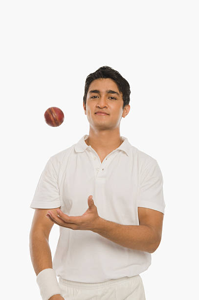 Bowler tossing a cricket ball