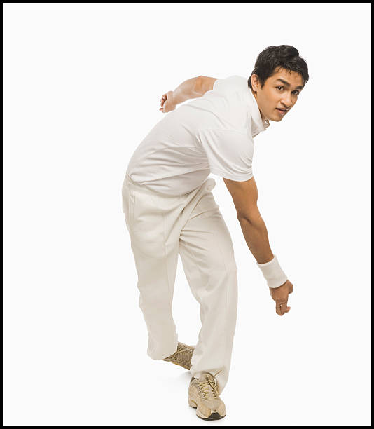 Cricket bowler in action stock photo