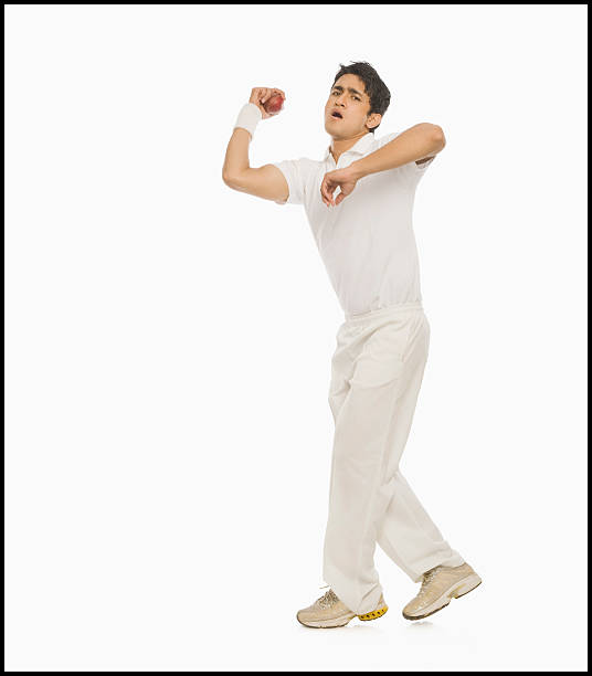 Cricket bowler in action stock photo